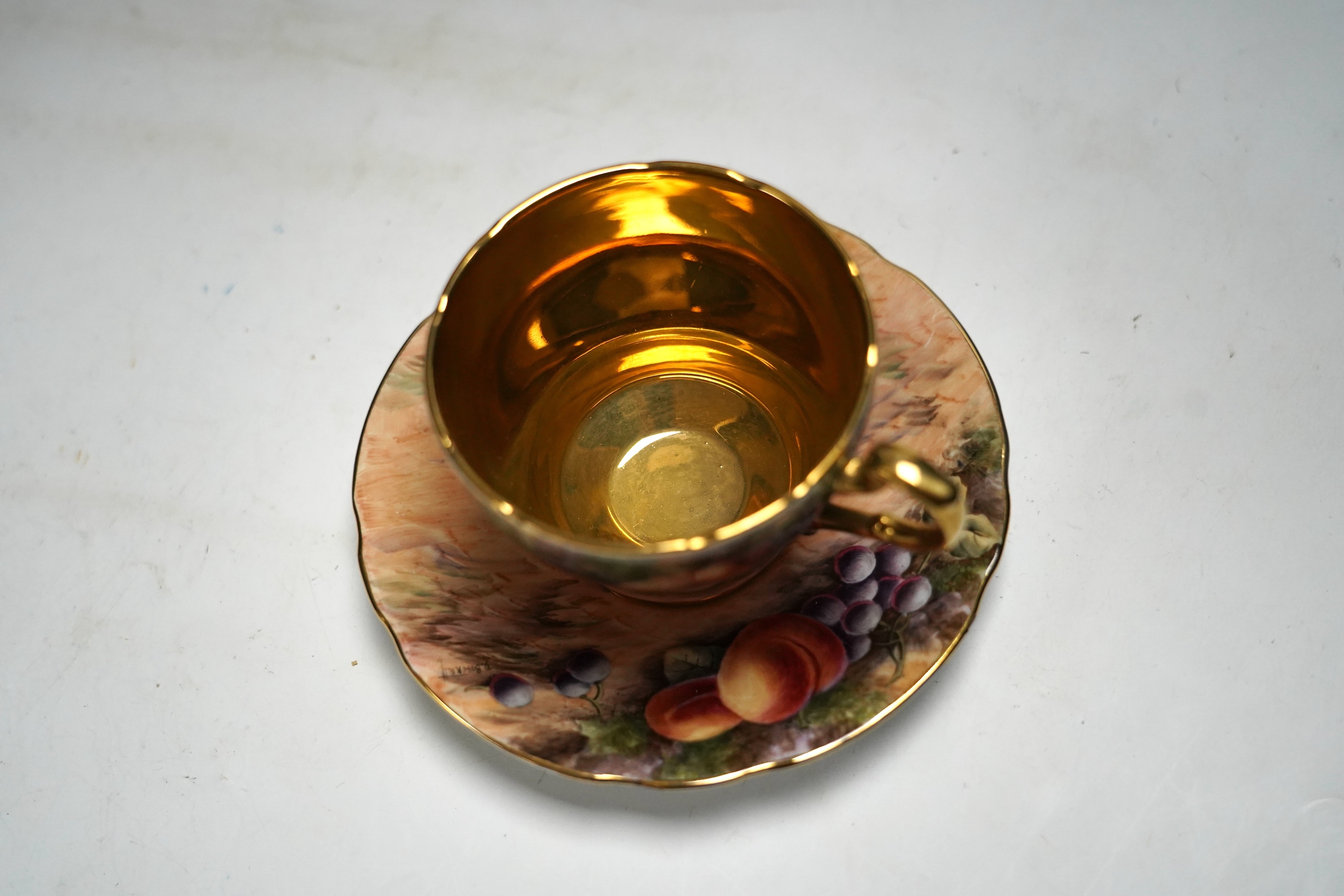 A tea set painted with still life of fruit, Studio D.R.B., comprising six cups and saucers, two bowls and two plates